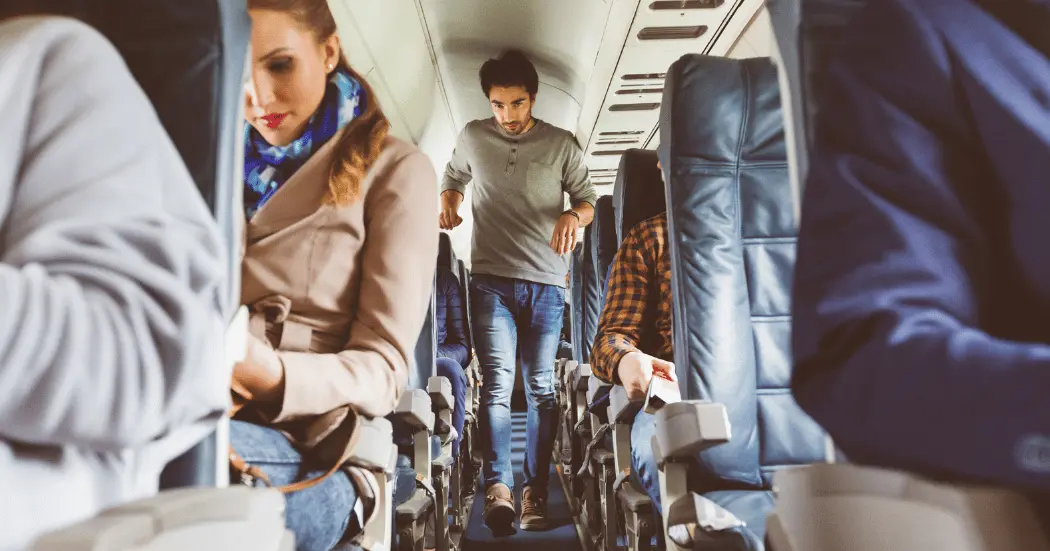 An economy airline passenger boards a plane.