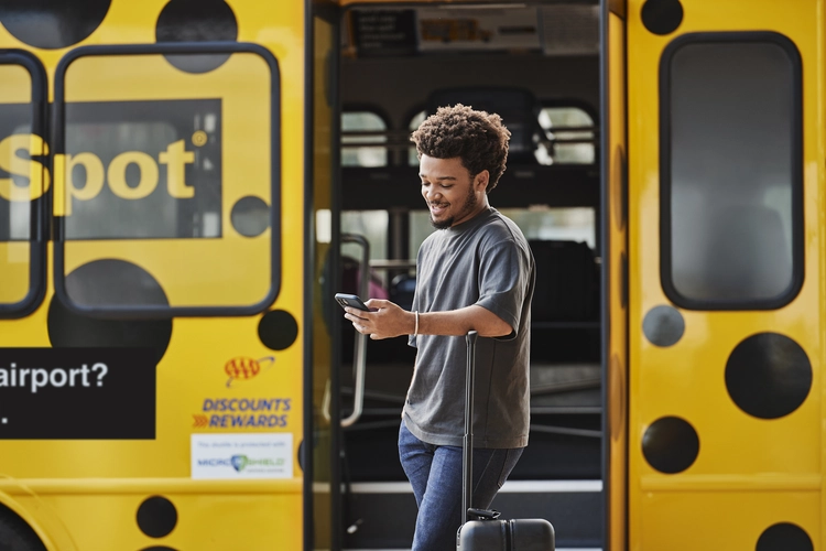 Parking Spot customer on a shuttle with a phone