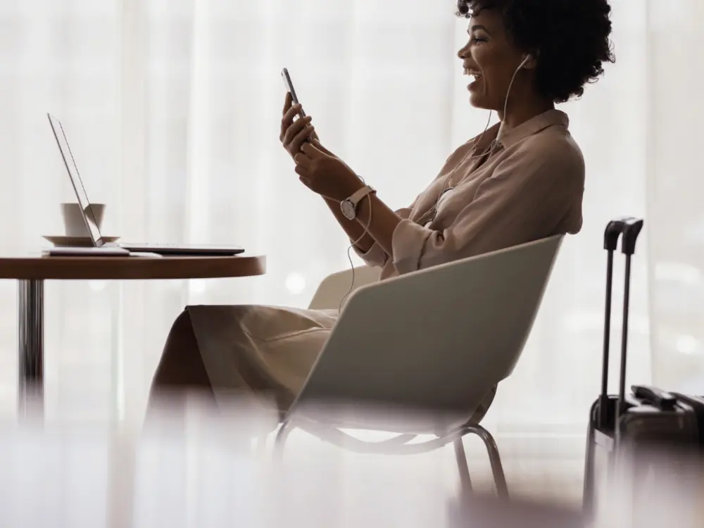 A business traveler works remotely in an airport lounge.