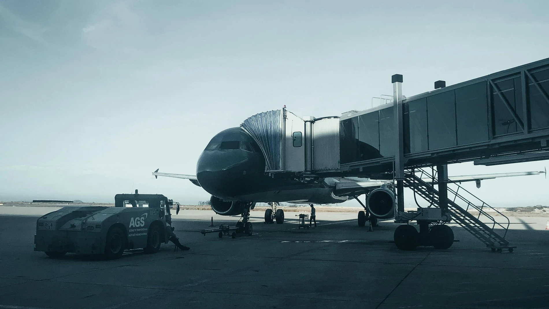 Passenger jet attached to jetway for boarding.