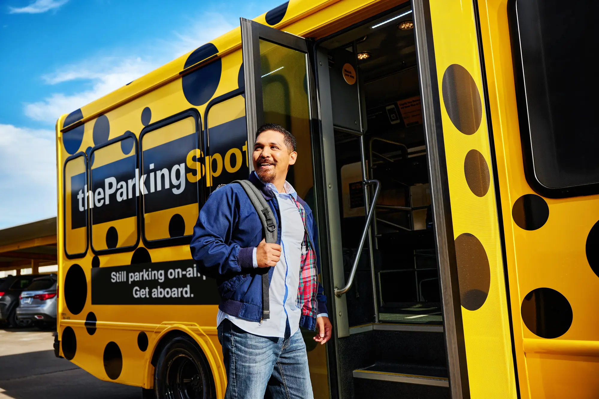 Business traveler boards The Parking Spot airport shuttle