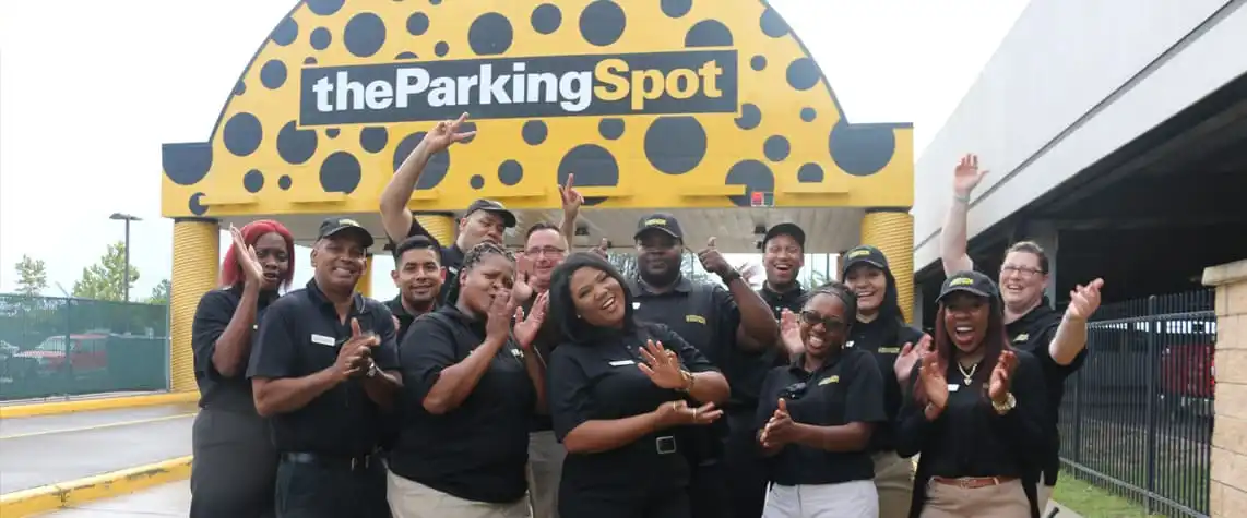 Some of The Parking Spot St. Louis field team applauding. They are standing in front of the TPS 1 entry.